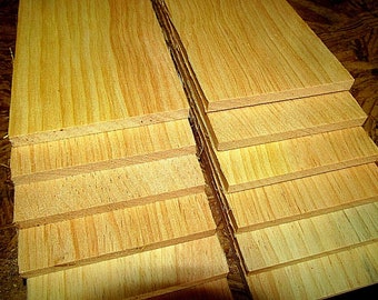 May include: A stack of unfinished wood boards, each with a light brown color and a wood grain pattern. The boards are stacked on top of each other, with the top board being the largest and the bottom board being the smallest.