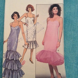 May include: A vintage sewing pattern for a dress with a ruffled skirt. The pattern is from Butterick and the pattern number is 5665. The pattern is for sizes 6-8-10.