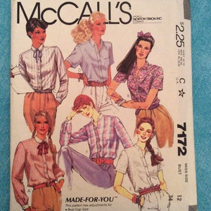 May include: A vintage McCall's sewing pattern envelope featuring illustrations of women's blouses and shirts. The envelope has the text "McCall's" at the top, with the price $2.25. The pattern number is 7172, and the bust size is 34.