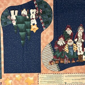 May include: Christmas stocking fabric panel with various cut-out shapes. Designs include plaid, gnomes, snowmen, and stars. The color palette features blue, green, red, and cream on a peach background. The panel is intended for sewing.