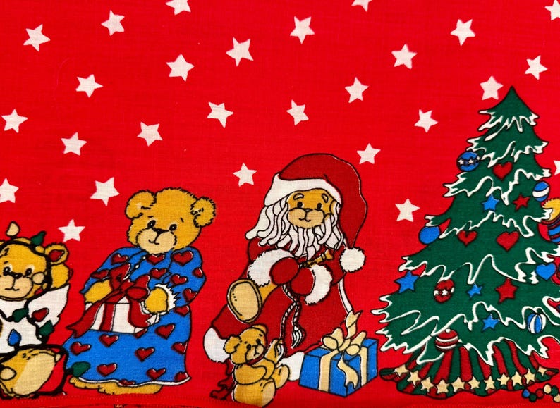 May include: A festive red fabric featuring white stars and cartoon teddy bears dressed for Christmas. One bear is dressed as Santa Claus, and another is wearing blue pajamas with red hearts. A decorated Christmas tree is also present.