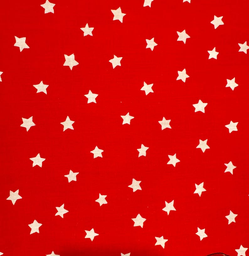 May include: A vibrant red fabric with a repeating pattern of white, five-pointed stars. The stars are evenly spaced across the surface, creating a playful and eye-catching design. This textile is suitable for various crafting and sewing projects.