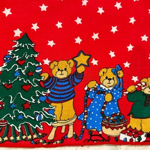 May include: A red Christmas-themed fabric featuring cartoon teddy bears and a decorated Christmas tree. The bears are dressed in festive attire, holding a star, a string of beads, and a candy cane. White stars are scattered across the red background.