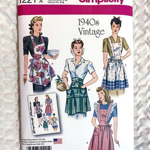 May include: Simplicity 1221 A sewing pattern featuring vintage 1940s apron designs. The package shows illustrations of aprons with floral, striped, and patterned details. The text "1940s Vintage" is displayed prominently.