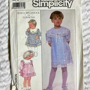 May include: Simplicity sewing pattern number 8885, size 3, for a girl's dress. The pattern includes three different styles of dresses, all with lace trim. The pattern is by Jessica McClintock for Gunne Sax.