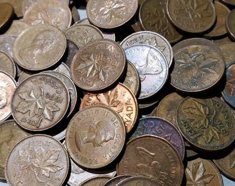 May include: A collection of Canadian one-cent coins featuring a maple leaf design. The coins are in various states of wear and patina, with some showing signs of age and use. The coins are arranged in a random pattern, with some overlapping.