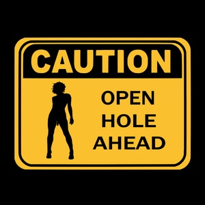 May include: A yellow caution sign with black text and a silhouette of a person. The sign reads "CAUTION OPEN HOLE AHEAD".