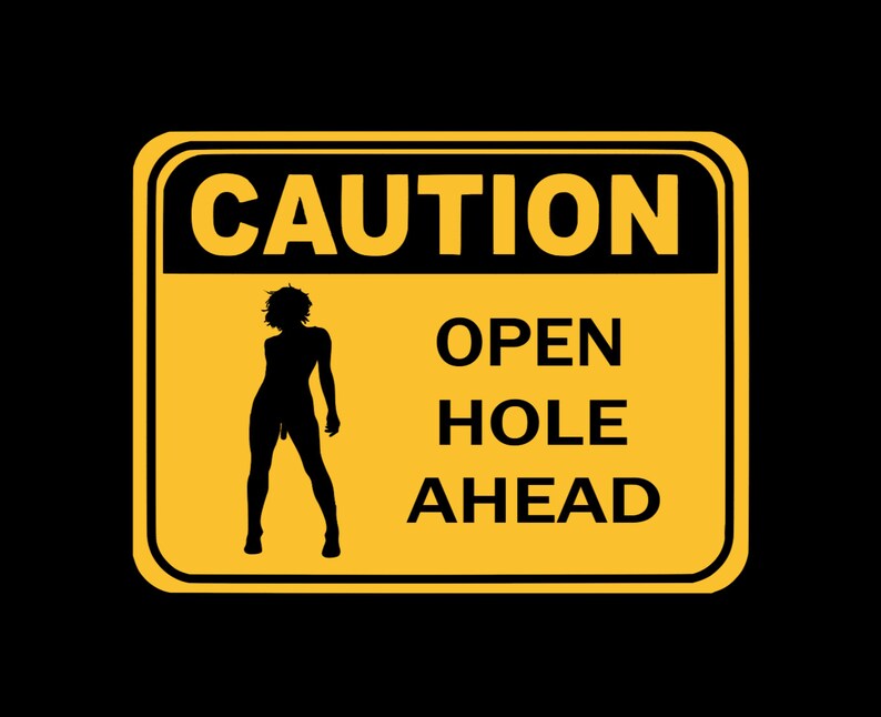 May include: A yellow caution sign with black text and a silhouette of a person. The sign reads "CAUTION OPEN HOLE AHEAD".