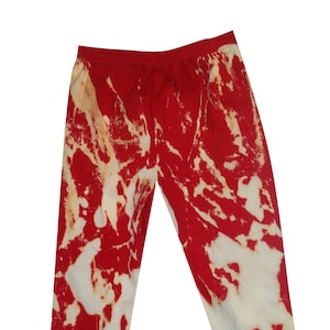 May include: Red and white tie-dye leggings with a marbled pattern.