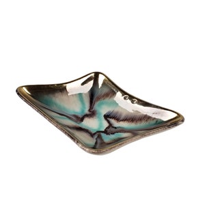 May include: A square ceramic serving dish with a gold metallic glaze and a swirling pattern of teal, white, and brown.