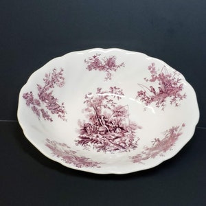 May include: A white ceramic bowl with a scalloped edge and a purple floral pattern. The bowl features a central scene of people fishing in a wooded area.