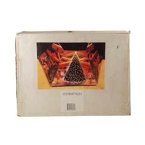 May include: A white cardboard box with a picture of a Christmas tree with lights inside a log cabin. The box has the text "ITEM#P74251" printed on it.