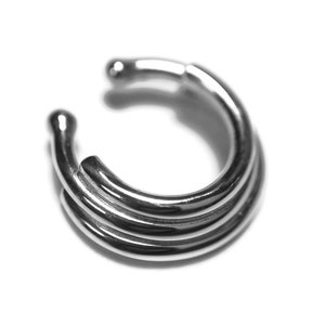 May include: A silver nose ring with a triple band design.