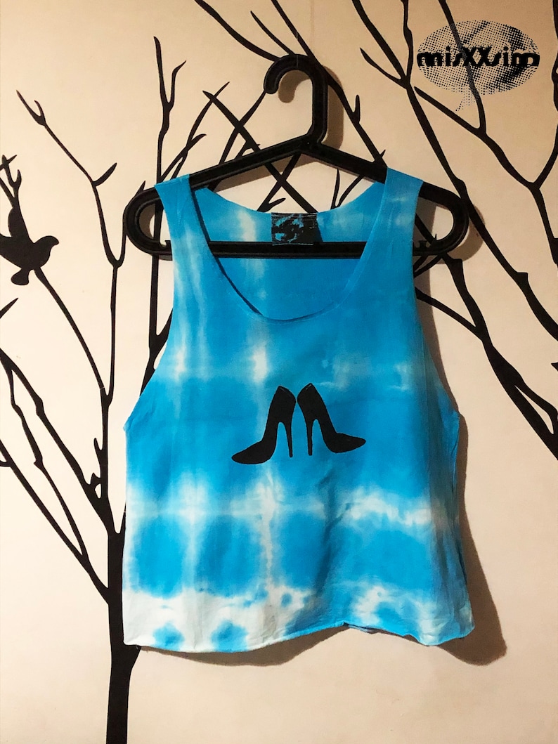 May include: A blue tie-dye tank top with a white design of two high-heeled shoes.