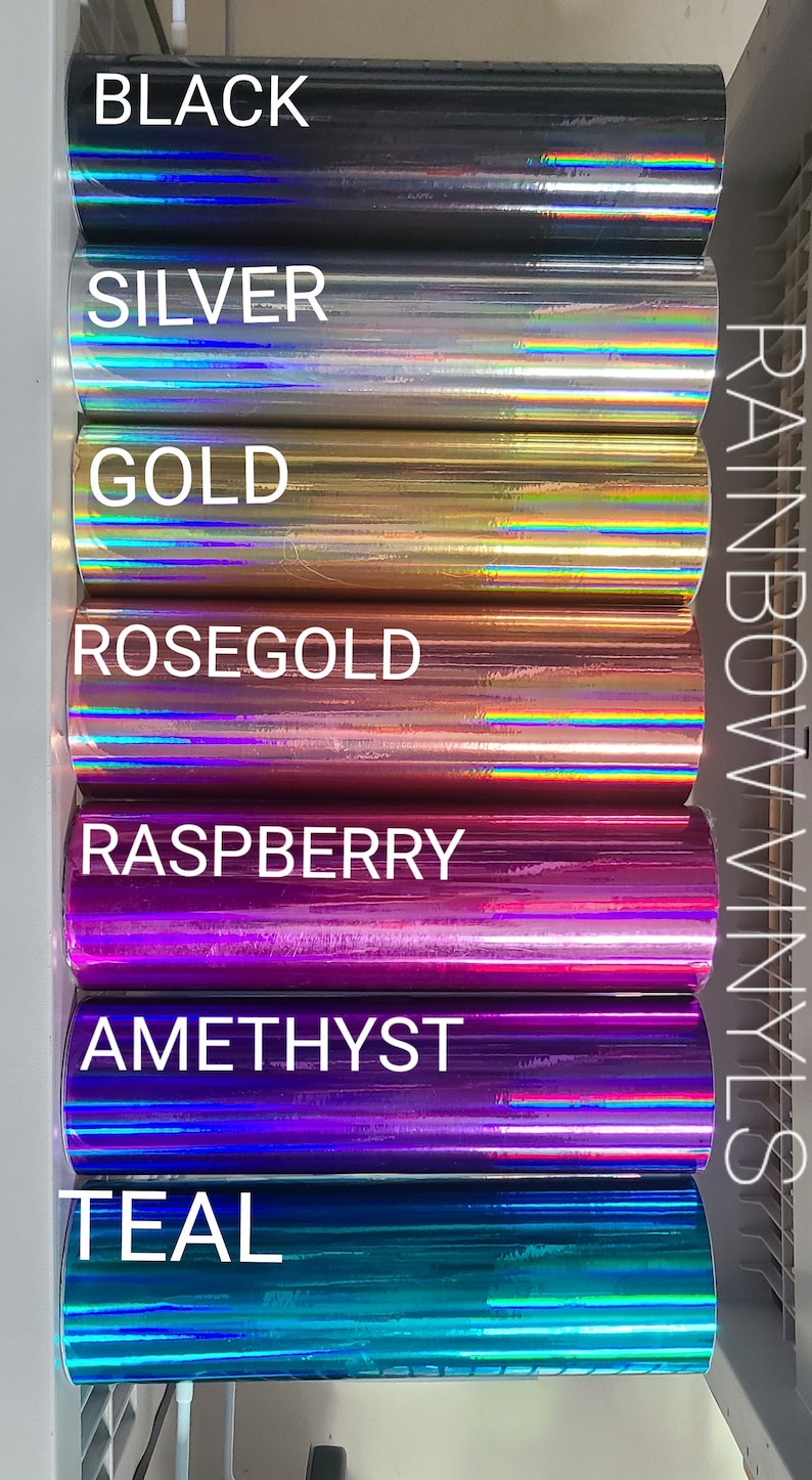 May include: A variety of rainbow vinyl rolls in different colors, including black, silver, gold, rose gold, raspberry, amethyst, and teal. The rolls are labeled with their respective colors.