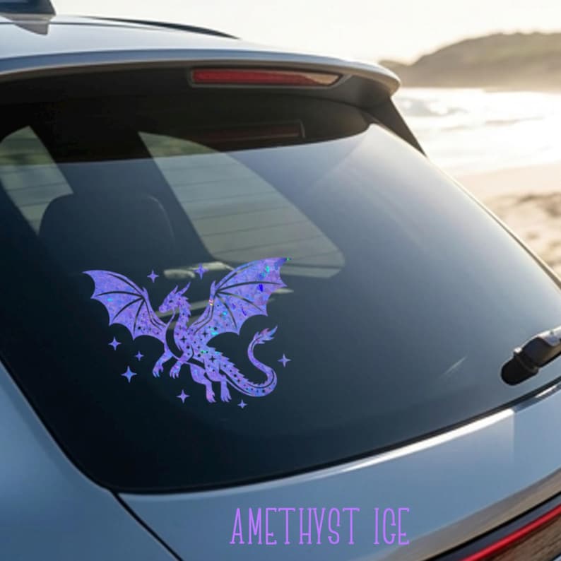 May include: A purple dragon decal with iridescent wings and star accents is affixed to a car window. The text "AMETHYST ICE" is displayed below the dragon. The dragon is a fantasy-themed product.