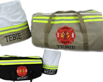 May include: A tan duffel bag and a black duffel bag, each featuring yellow reflective stripes, a red embroidered fire department emblem, and the names TEBIE or WRIGHT. Two matching white towels with reflective trim and names are included.