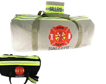 May include: A tan duffel bag with olive green straps, featuring a red and yellow Fire Dept emblem, reflective yellow and silver stripes, and the name SALLEMI. A smaller black duffel bag with the same emblem and the name WRIGHT is also shown.