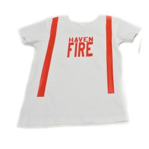 May include: White t-shirt with red stripes down the sides and the words "HAVEN FIRE" printed in red on the front.