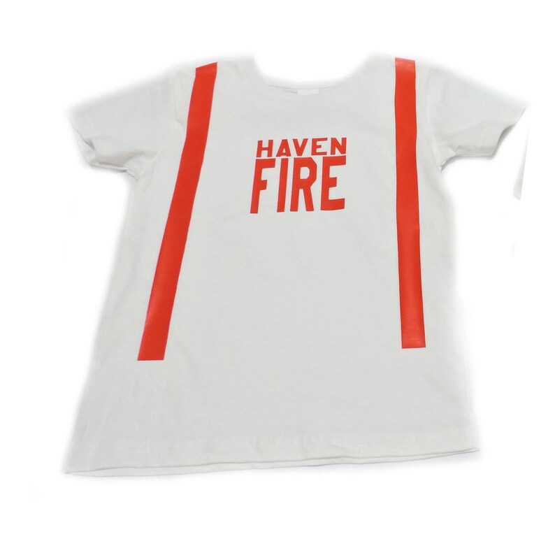 May include: White t-shirt with red stripes down the sides and the words "HAVEN FIRE" printed in red on the front.