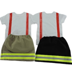 May include: Two firefighter costumes for kids. Each costume includes a white t-shirt with red stripes and a skirt with yellow reflective tape. One skirt is khaki and the other is black.