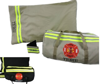 May include: A tan duffel bag and pillowcase set featuring yellow reflective stripes and a red fire department emblem with the name TEBIE. A smaller black duffel bag and pillowcase set with yellow reflective stripes and the name WRIGHT is also shown.