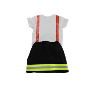 May include: A white t-shirt with red stripes and a black skirt with yellow reflective tape. The skirt has an elastic waistband.