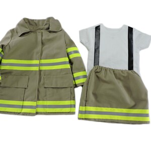 May include: A child's firefighter costume set, including a tan jacket with reflective stripes, a white t-shirt with black suspenders, and matching tan shorts. The jacket has two pockets.