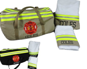 May include: A tan duffel bag and a black duffel bag, each featuring yellow reflective stripes, a red fire department emblem, and the names COLES or WRIGHT. Included are matching white towels with tan or black trim and reflective stripes.