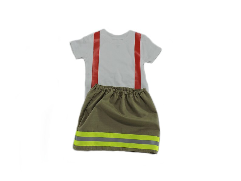 May include: A white t-shirt with red suspenders and a green skirt with yellow reflective stripes. The skirt has an elastic waistband.