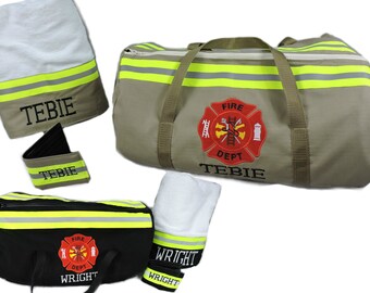May include: A tan duffel bag with yellow reflective stripes and a red Fire Dept emblem with the name TEBIE, a matching tan towel, a black duffel bag with yellow stripes and a red Fire Dept emblem with the name WRIGHT, and a matching white towel.