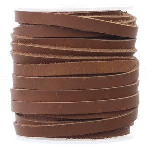 May include: A spool of brown leather strips, tightly wound. The leather appears to be a medium brown color, with a slightly textured surface. The strips are flat and uniform in width, suggesting they are cut from a larger piece of leather. The spool is against a white background.
