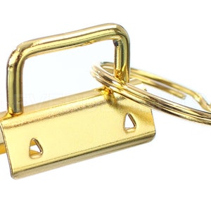 May include: Gold-toned metal key ring with a D-ring and a loop for attaching to a bag or belt.
