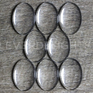 100 Pack - 18x25mm Oval Glass Cabochons - Clear Transparent Solid Glass Magnifying Cabs - 3/4&quot; x 1&quot;