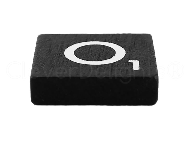 May include: Black wooden block with the letter "O" in white paint.