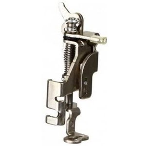 May include: A silver sewing machine foot with a spring-loaded mechanism and a lever for adjusting the height. The foot is designed for use with a sewing machine.