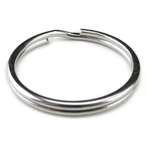 May include: A silver key ring with a double loop design.