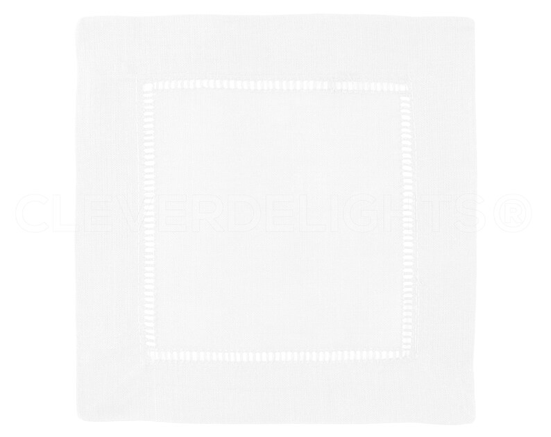 May include: White linen napkin with a white embroidered border.