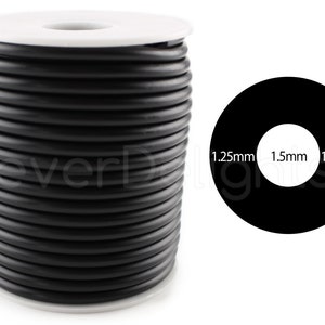 May include: A spool of black round elastic cord, 1.5 mm thick, with a white label. The label shows the cord's thickness in millimeters: 1.25 mm, 1.5 mm, 1.25 mm.
