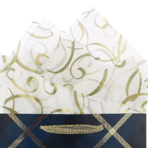 May include: White tissue paper with a gold swirl pattern, filling a blue and gold plaid gift bag.