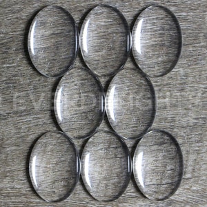 50 Pack 18x25mm Oval Glass Cabochons Clear Transparent Solid Glass Magnifying Cabs 3/4 x 1 image 1