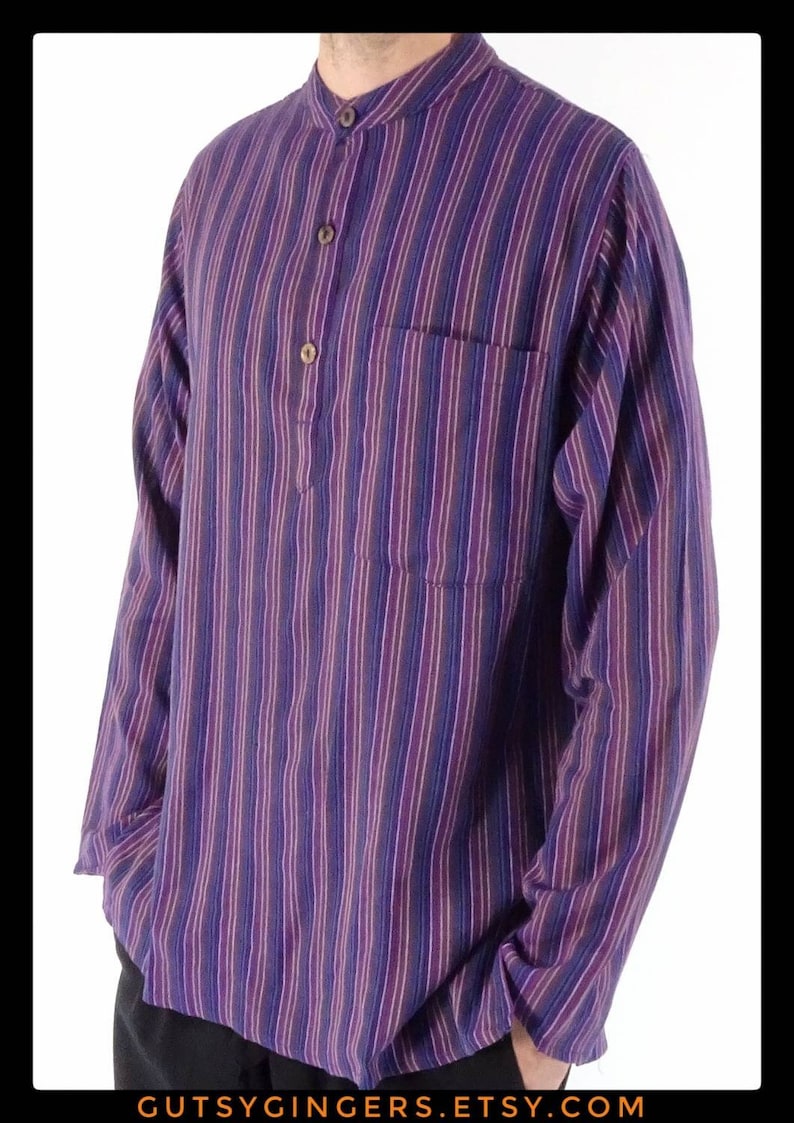 May include: A long-sleeved striped shirt with a mandarin collar and a single button closure. The shirt is made of a soft, comfortable fabric and has a pocket on the left chest.