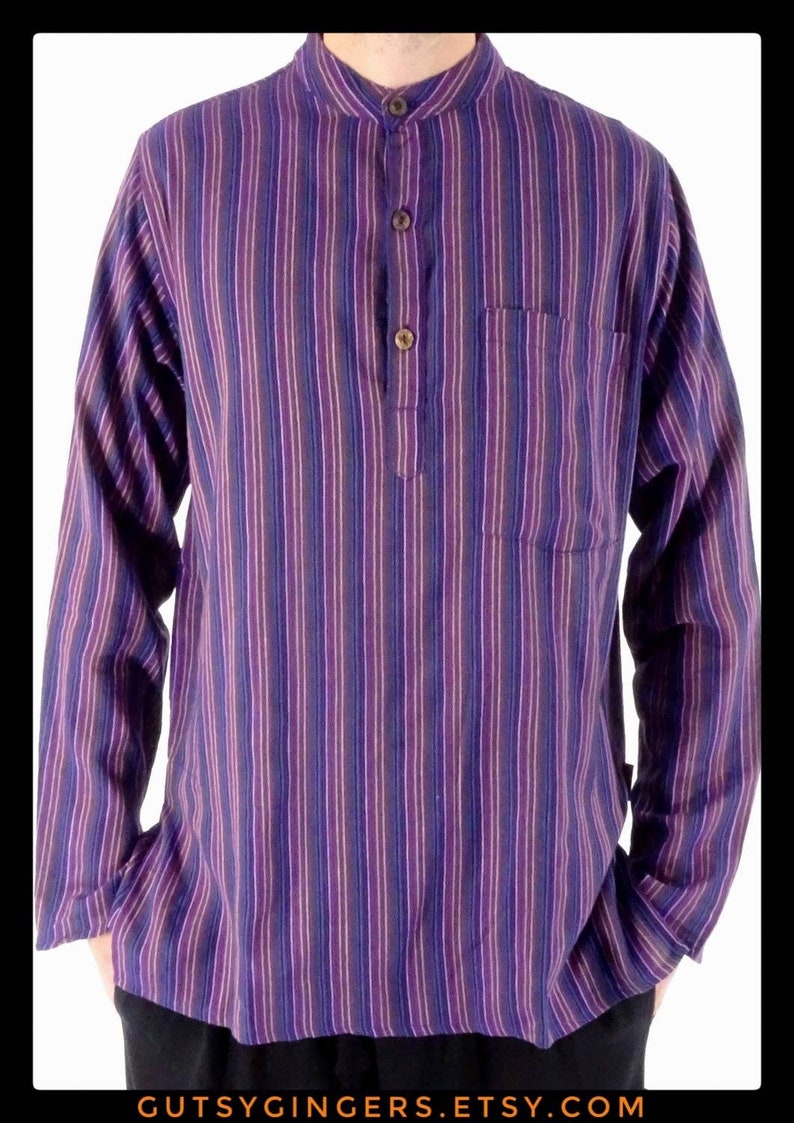 May include: A purple and white striped long-sleeved shirt with a mandarin collar and a single button closure. The shirt has a chest pocket.