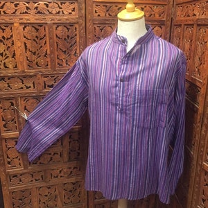May include: A long-sleeved shirt with a purple, white, and pink striped pattern. The shirt has a mandarin collar and a single button closure.
