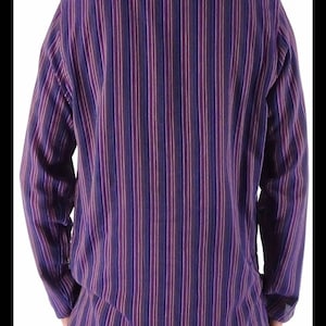 May include: A long-sleeved button-down shirt with a vertical striped pattern in shades of purple, blue, and white.