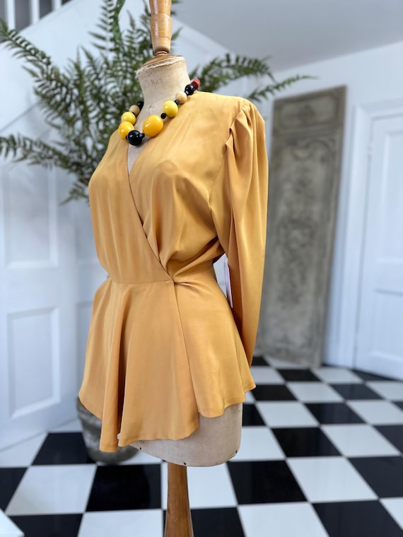 Blusa cruzada de manga larga de seda vintage de los años 80 en color mostaza