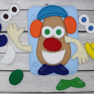 Könnte beinhalten: Ein Filzspielzeug-Set mit einer Mr. Potato Head-Figur mit verschiedenen Gesichtszügen, darunter Augen, Ohren, eine Nase, ein Mund und einen Hut. Das Set enthält auch ein Paar Schuhe, einen Hut und zwei Arme.