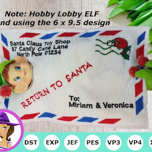 May include: A white felt envelope with red, white, and blue trim. The envelope has the words "Return to Santa" and "Santa Claus Toy Shop" embroidered on it. The envelope is decorated with a green elf head peeking out of the top and a red and green holly sprig on the right side. The text "To: Miriam & Veronica" is embroidered on the envelope. The words "DST EXP JEF PES VP3 VP4 XXX" are printed below the envelope.