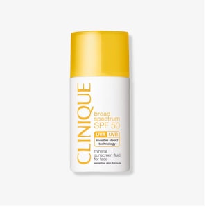 May include: A white bottle of Clinique broad spectrum SPF 50 mineral sunscreen fluid for face, with a yellow cap. The bottle has the text "UVA UVB invisible shield technology" and "sensitive skin formula".