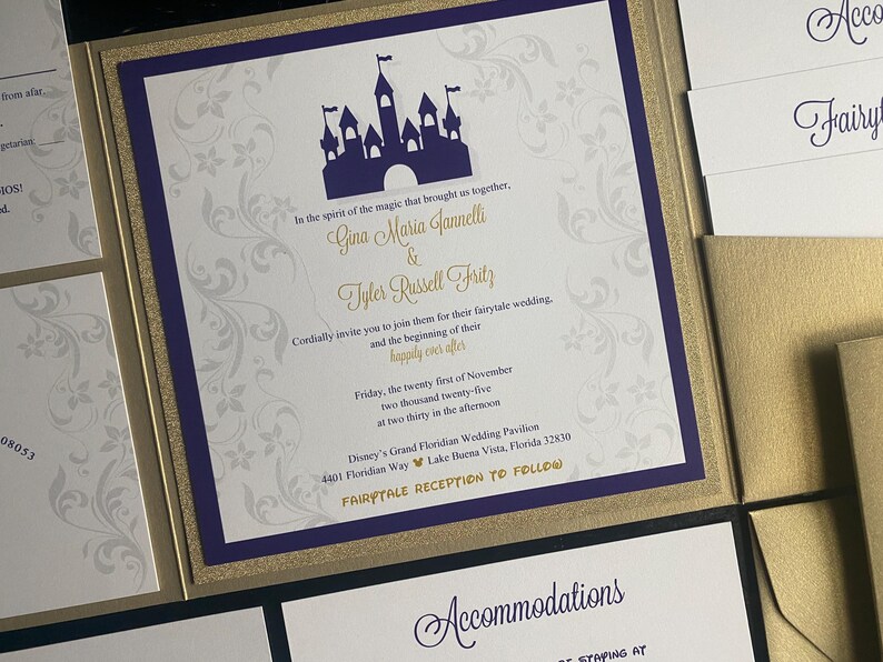 May include: Wedding invitation with a purple castle silhouette, gold accents, and floral design. The invitation includes the names Gina Maria Jannelli & Tyler Russell Fritz, and event details. The invitation is part of a set.